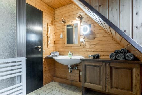a bathroom with a sink and a staircase at Apartment am Bullerbach Deister in Barsinghausen