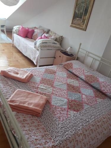 a bedroom with a bed with a quilt on it at Villa Carmen in Sali