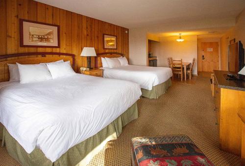 a hotel room with two beds and a television at Fairmont Hot Springs Resort in Fairmont Hot Springs