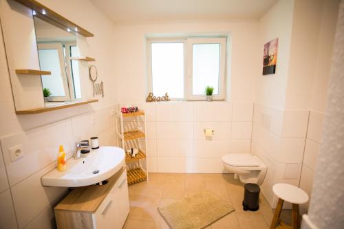 a bathroom with a sink and a toilet at Strandchalet Elmo I in Wremen in Wremen