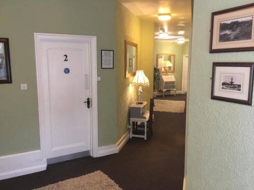 a hallway with green walls and a white door at The Stockton Arms Hotel in Stockton-on-Tees