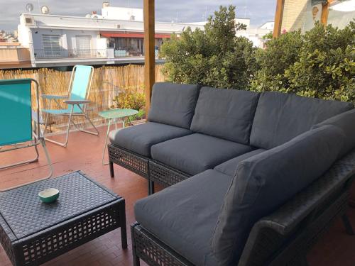 a couch sitting on a patio with a table at B&B La Terrazza Near The Beach in Bari
