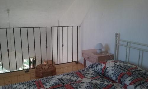 a bedroom with a bed and a table with a lamp at Villa Carmen in Sali