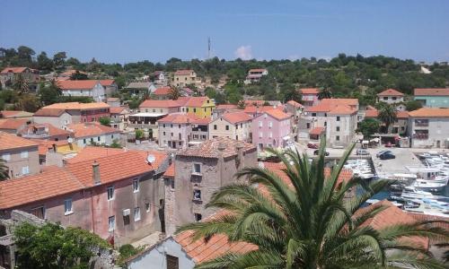 a view of a town with houses and a palm tree at Villa Carmen in Sali