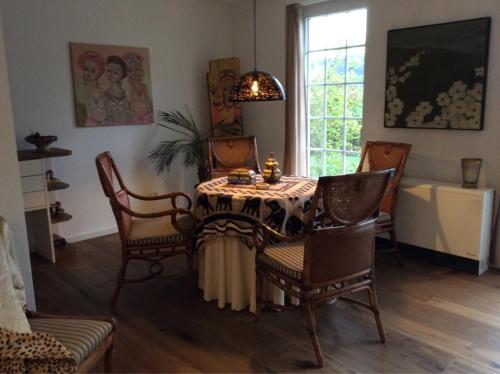 a dining room with a table and chairs and a window at Wollmeiner's Lodge in Arnsberg