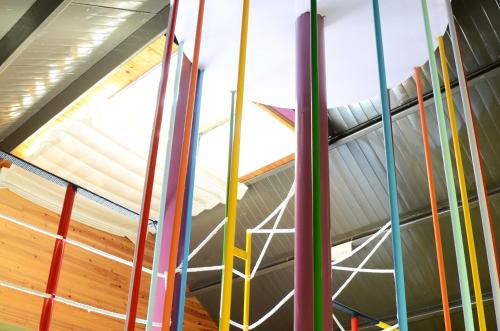 a room with a roof with colorful poles at Kaohsiung Meinong Rabbit Paul Homestay B&B in Meinong