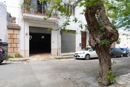 a white car parked in front of a garage at B&B La Stradella in Ostuni