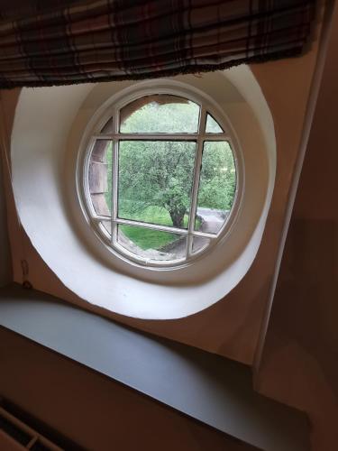 anorthole window in a building with a white at Leithen Lodge in Innerleithen