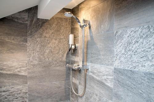 a shower with a shower head in a bathroom at Blackbird Luxury Apartments Room 4 in Blackpool