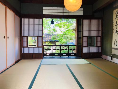 a room with a large window and a room with at Sofuan in Kanazawa