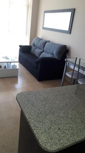 a living room with a couch and a table at Panoramico Playa de Altar I in Barreiros