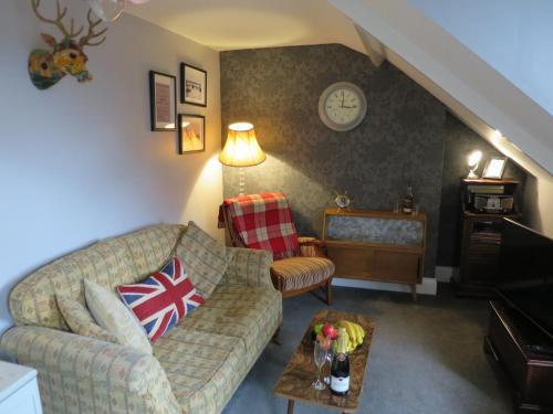 a living room with a couch and a table at Parkside Apartments in Newcastle upon Tyne