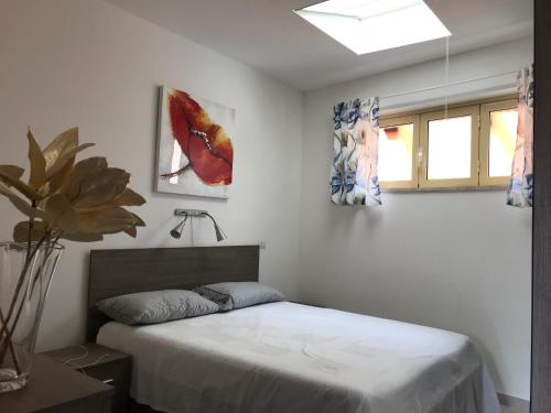 a bedroom with a bed and two paintings on the wall at 35G Borgonovo in Pizzo