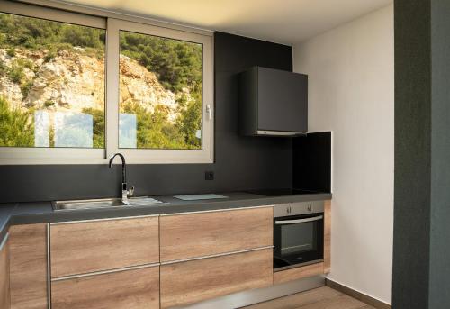 a kitchen with a sink and a window at NV Illusion in Chania Town