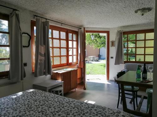 a bedroom with a bed and a desk and a table at Casetta del Molo in Mandello del Lario