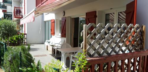 a porch of a house with a wooden fence at Xapital in Hasparren
