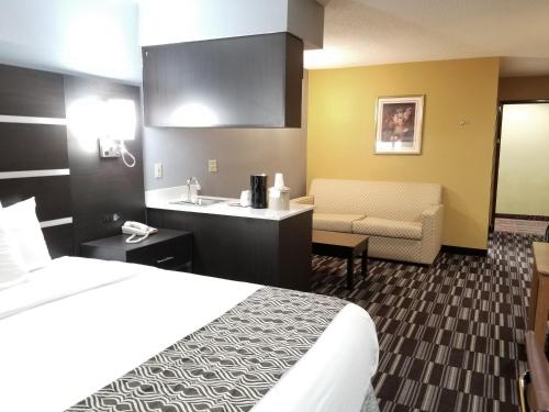 a hotel room with a bed and a sink at Microtel Inn & Suites by Wyndham Riverside in Dayton