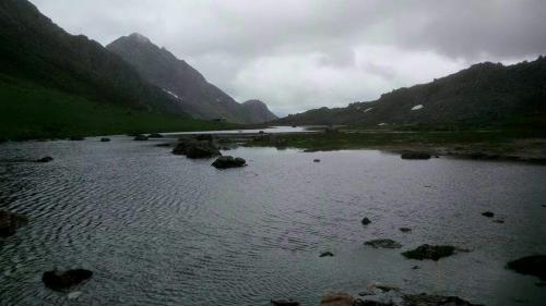 a river in the middle of a valley with mountains at La Casita de la cruz in Langreo