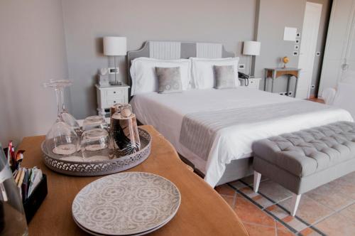 a bedroom with a large bed and a coffee table at Villa Le Terrazze Charming Rooms in Taormina