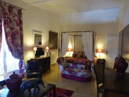 a bedroom with a bed and a dog in a room at Mas de la Chapelle in Arles