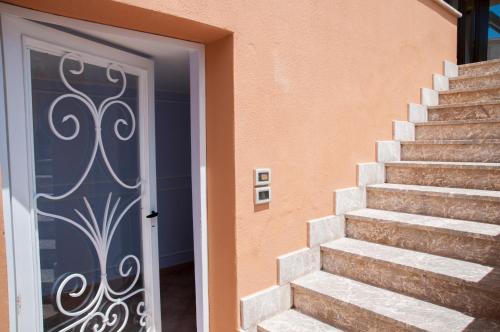 a set of stairs with a door in front of a house at Villa Le Terrazze Charming Rooms in Taormina