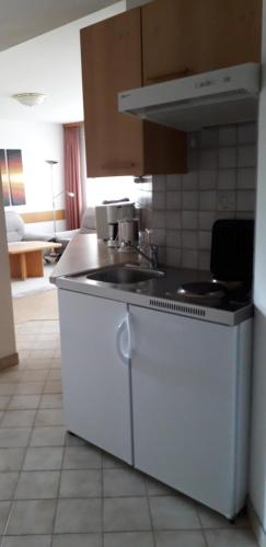 a kitchen with a sink and a stove at Gästehaus Tarmann in Annenheim