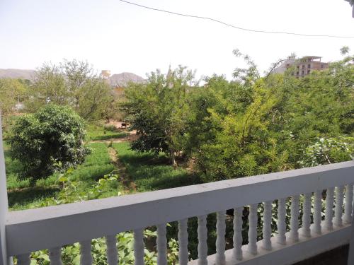 a balcony with a view of a garden at Pushkar Vela Resort in Pushkar