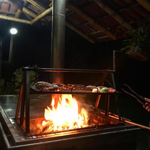 a grill with food cooking over a fire at Finca Hotel Santana in Montenegro