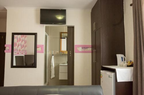 a bathroom with a sink and a mirror at A-Z Boutique Guesthouse in Windhoek