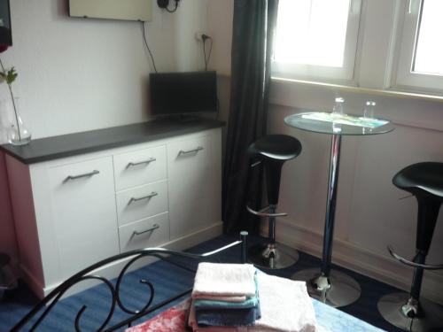 a bedroom with a bed and a table and stools at Hotel an der Fähre in Sankt Goar