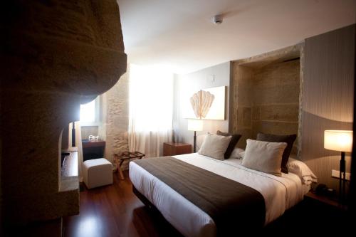En eller flere senge i et værelse på Carris Casa de la Troya