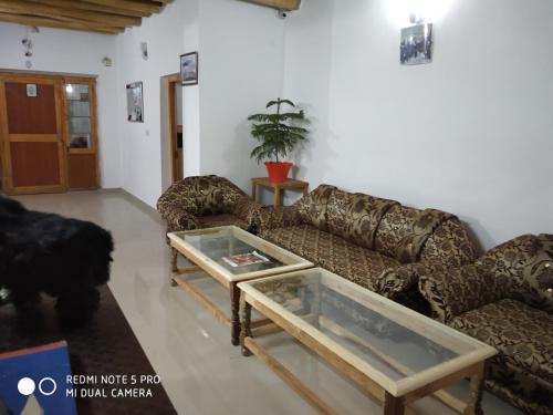 a living room with a couch and a table at Palay Shay Shay in Leh