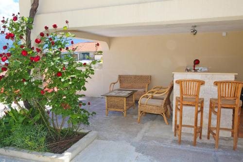 a patio with chairs and a table and a tree at Dubravcevic Residence in Tivat