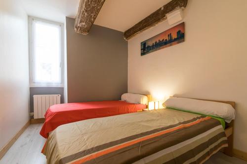 two beds sitting next to each other in a room at COSY HOME PERIGUEUX in Périgueux