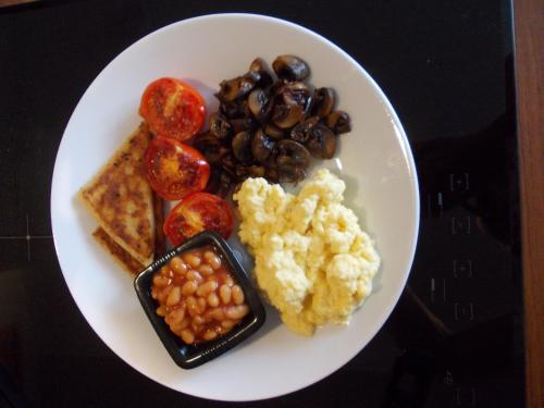 a plate of food with eggs tomatoes beans and bread at Crag Na Cor B&B in Culdaff