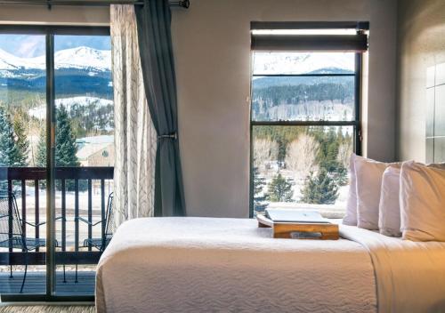 a bedroom with a bed and a large window at Breck Inn in Breckenridge