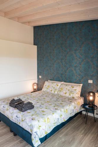 a bedroom with a bed with two lamps on it at Alla Riva in Verona