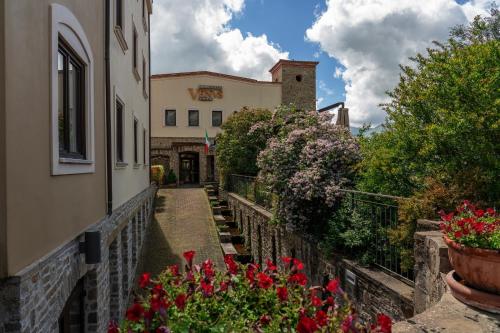 a walkway leading to a building with flowers at Villa Venus Resort & SPA in Atena Lucana
