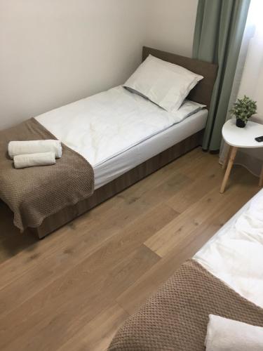 a bedroom with a bed and a wooden floor at Apartament 212 in Klikuszowa