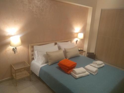 a bedroom with a bed with towels on it at Villa Anthira in Ropanianá
