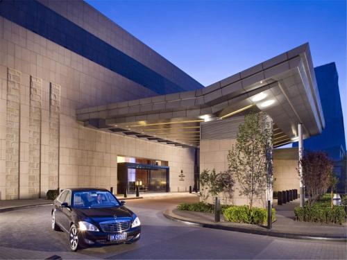 a car parked in front of a building at Grand Millennium Beijing in Beijing