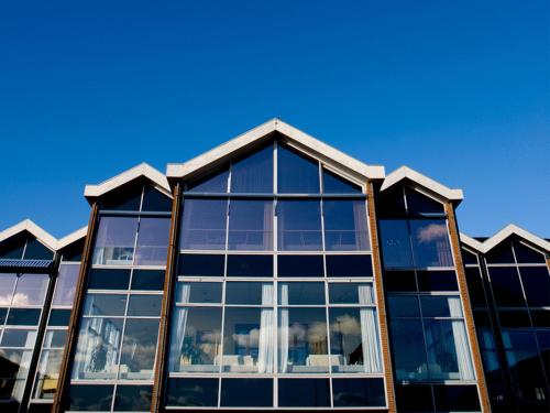 a building with glass windows on the top of it at Skaga Hotel in Hirtshals