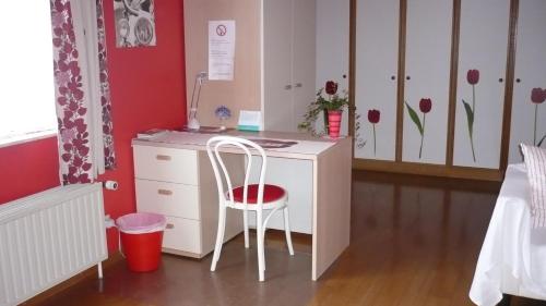 een wit bureau met een stoel in een slaapkamer bij B&B Vanderstraeten-Bryxis in Grimbergen