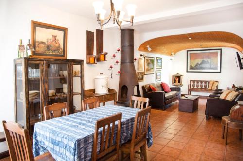 a kitchen and living room with a table and a fireplace at Villas Santa Ana in Antigua Guatemala