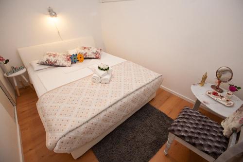 a small room with a bed and a table at Apartment Maroma in Split