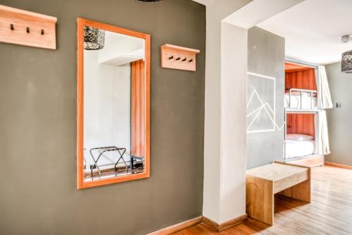 a room with a mirror and a bench at qema Arequipa in Arequipa