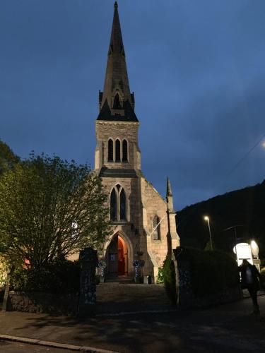 an old church with a steeple at night at The Auld Kirk in Ballater