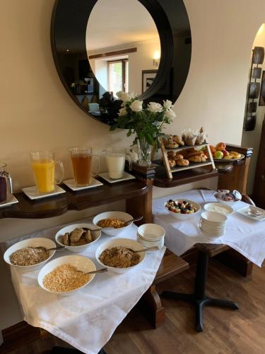a table with many plates of food and a mirror at The Auld Kirk in Ballater
