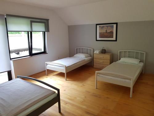 a room with two beds and a dresser in it at Holiday home RIVER NATURE in Jajce