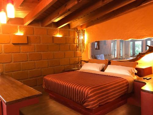 Säng eller sängar i ett rum på Hotel puesta del sol